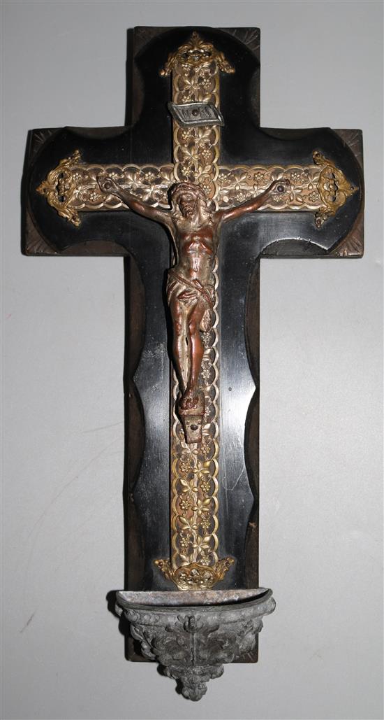A metal and wood crucifix with stoup